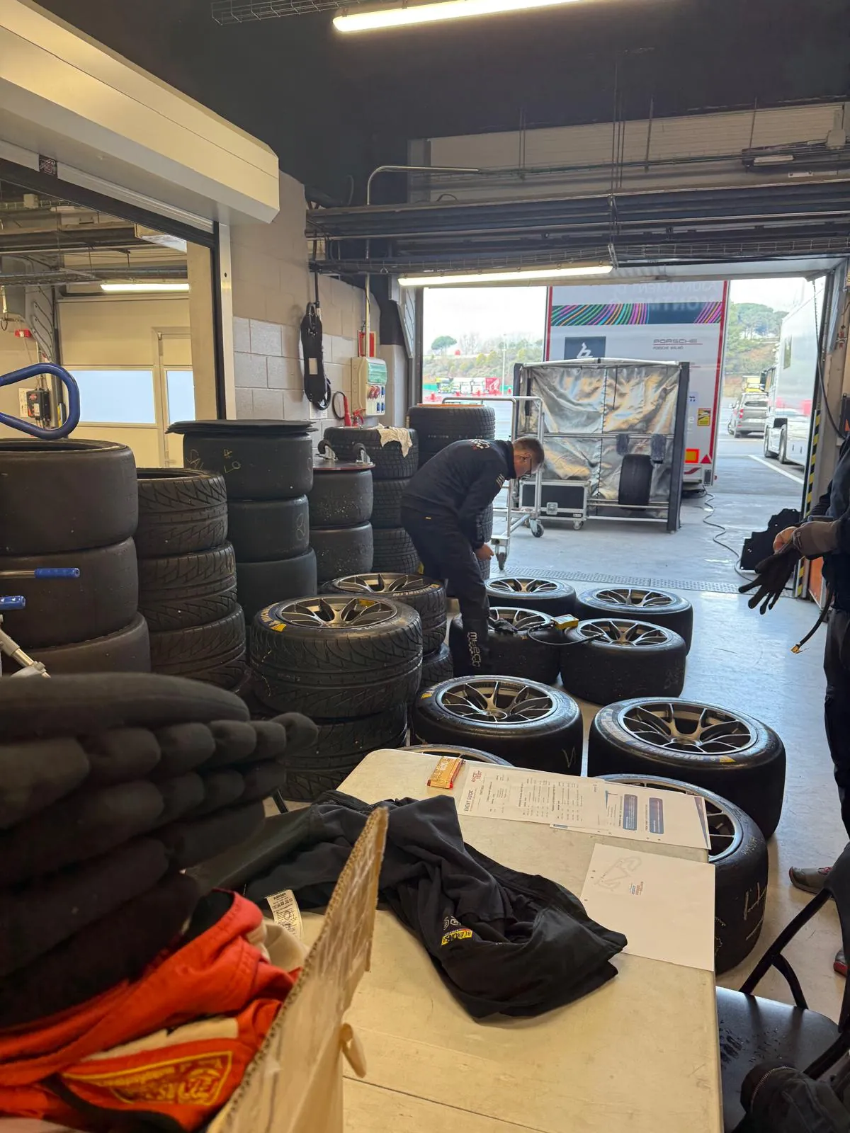 Tyre stacks and mounted wheels in the garage, sorted through against the weekend allocation