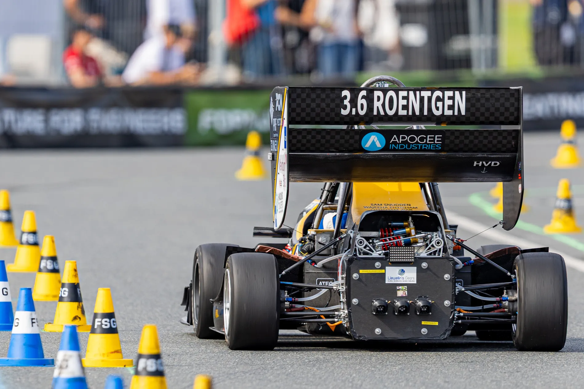 TBRe26 from behind at Formula Student Germany, rear wing and rear suspension in view, marker cones either side